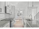 Modern kitchen with white shaker cabinets, granite countertops, and stainless steel appliances at 8610 Brushfoot Way # 106, Raleigh, NC 27616