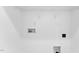 Simple laundry room with overhead shelving and space for a washer and dryer at 8610 Brushfoot Way # 106, Raleigh, NC 27616