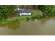 Aerial view of a renovated ranch home on waterfront lot at 889 Burlington Rd, Roxboro, NC 27573