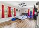 Bright bedroom with wood floors, a baseball-themed bed, and red curtains at 889 Burlington Rd, Roxboro, NC 27573