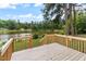 Wooden deck overlooking a tranquil lake, perfect for outdoor relaxation at 889 Burlington Rd, Roxboro, NC 27573