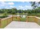 Wooden deck overlooking a tranquil lake, perfect for outdoor relaxation at 889 Burlington Rd, Roxboro, NC 27573