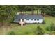 Back view of a renovated home with deck overlooking water at 889 Burlington Rd, Roxboro, NC 27573