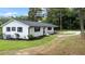 Side view of a renovated white brick ranch home at 889 Burlington Rd, Roxboro, NC 27573