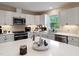 Modern kitchen island with white quartz countertops and storage at 889 Burlington Rd, Roxboro, NC 27573