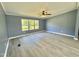 Living room with gray walls, ceiling fan, and wood-look floors at 9199 Virgilina Road Rd, Roxboro, NC 27574