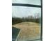 View of backyard showcasing pond, and wooded perimeter from a window at 9349 Kitchin Farms Way # 463, Wake Forest, NC 27587