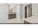 Well-lit bathroom with a double vanity, white tile floors, and a walk-in closet at 9349 Kitchin Farms Way # 463, Wake Forest, NC 27587