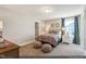 Cozy bedroom with decorative pillows, bedside table, and plush poufs on carpet at 9349 Kitchin Farms Way # 463, Wake Forest, NC 27587