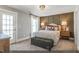 Serene bedroom with a decorative wall, carpeted floors, and a comfortable bed setup at 9349 Kitchin Farms Way # 463, Wake Forest, NC 27587