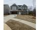 Charming two-story home with stone accents, attached garage, and front yard at 9349 Kitchin Farms Way # 463, Wake Forest, NC 27587