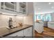 A kitchen with white cabinets, stainless appliances, an island, and wood floors at 9349 Kitchin Farms Way # 463, Wake Forest, NC 27587