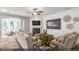 A living room with a fireplace, large screen television, and a large bay window for natural light at 9349 Kitchin Farms Way # 463, Wake Forest, NC 27587