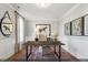 The home office is appointed with a desk, chair, area rug, and large wall mirror at 9349 Kitchin Farms Way # 463, Wake Forest, NC 27587