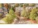 An aerial view of a home, trees, and neighborhood in the fall at 108 Cross Oaks Pl, Holly Springs, NC 27540