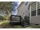 Backyard view of home with deck and landscaping at 108 Cross Oaks Pl, Holly Springs, NC 27540