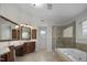 Luxurious Primary bathroom with double vanity, large tub, and glass-enclosed shower at 108 Cross Oaks Pl, Holly Springs, NC 27540
