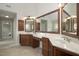 Bathroom featuring dual sinks with dark wood cabinetry, large mirrors and tiled floor at 108 Cross Oaks Pl, Holly Springs, NC 27540