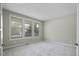 Serene bedroom with neutral carpet, multiple windows, and ample space at 108 Cross Oaks Pl, Holly Springs, NC 27540