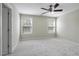 Bright bedroom with neutral paint, carpet, ceiling fan, and natural light from two windows at 108 Cross Oaks Pl, Holly Springs, NC 27540