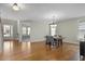 Elegant dining area with hardwood floors and contemporary chandelier for stylish living at 108 Cross Oaks Pl, Holly Springs, NC 27540