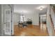 Open-concept dining room featuring hardwood floors, modern chandelier, and ample natural light at 108 Cross Oaks Pl, Holly Springs, NC 27540