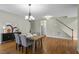 Well-appointed dining room with hardwood floors, classic decor, and adjacent living spaces at 108 Cross Oaks Pl, Holly Springs, NC 27540