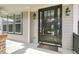 Stylish front door with sidelights, brick accents, and elegant outdoor lighting at 108 Cross Oaks Pl, Holly Springs, NC 27540