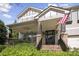 Inviting craftsman-style home with a welcoming front porch, brick accents, and American flag at 108 Cross Oaks Pl, Holly Springs, NC 27540