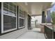 Charming front porch with ceiling fan, brick columns, and views of the neighborhood at 108 Cross Oaks Pl, Holly Springs, NC 27540