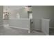 View of the second floor hallway with gray carpet and doors to other rooms at 108 Cross Oaks Pl, Holly Springs, NC 27540