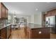 Open-concept kitchen with granite island flowing into dining and living spaces at 108 Cross Oaks Pl, Holly Springs, NC 27540