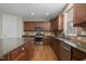 Well-lit kitchen with stainless steel appliances, central island, and beautiful wood cabinets at 108 Cross Oaks Pl, Holly Springs, NC 27540