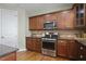 Beautiful kitchen showcases stainless steel range, microwave, and elegant wood cabinets at 108 Cross Oaks Pl, Holly Springs, NC 27540