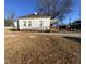 Rear view of a white house with a ramp and yard at 1124 S Church St, Rocky Mount, NC 27803
