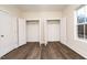 Bright bedroom with two spacious closets and wood-look flooring at 1127 Elmo St, Durham, NC 27701