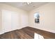 Bedroom featuring wood-look floors, a ceiling fan, and ample closet space at 1127 Elmo St, Durham, NC 27701