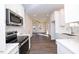 Open concept kitchen with stainless steel appliances and hardwood floors at 1127 Elmo St, Durham, NC 27701