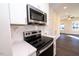 Stainless steel appliances and white cabinets in modern kitchen at 1127 Elmo St, Durham, NC 27701
