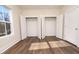 Well-lit bedroom featuring ample closet space and vinyl flooring at 1129 Elmo St, Durham, NC 27701