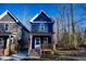 New construction home with navy blue siding and wooden porch at 1129 Elmo St, Durham, NC 27701