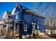 Side view of a charming two-story home with wooden porch at 1129 Elmo St, Durham, NC 27701