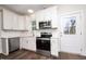 Modern kitchen with white cabinets, stainless steel appliances, and quartz countertops at 1129 Elmo St, Durham, NC 27701