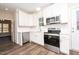 Modern kitchen with white cabinets, stainless steel appliances, and quartz countertops at 1129 Elmo St, Durham, NC 27701