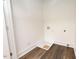 Bright laundry room with vinyl flooring and built-in shelving at 1129 Elmo St, Durham, NC 27701