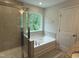 Bathroom featuring tub, shower and large window at 137 Stallion Way, Benson, NC 27504