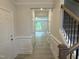 Bright foyer showcases wood floors, wainscoting, and staircase at 137 Stallion Way, Benson, NC 27504