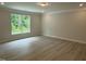 Open concept living room with wood floors and large window at 137 Stallion Way, Benson, NC 27504