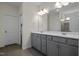 Double vanity bathroom with gray cabinets and a large mirror at 148 Cumberland Dr, Sanford, NC 27332
