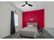Bright bedroom with a gray bed, red accent wall, and window coverings at 148 Cumberland Dr, Sanford, NC 27332